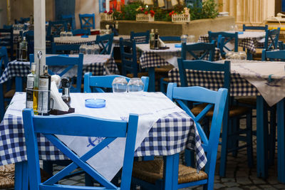 View of empty chairs and tables at sidewalk cafe