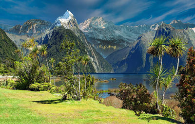 Scenic view of lake and mountains against sky