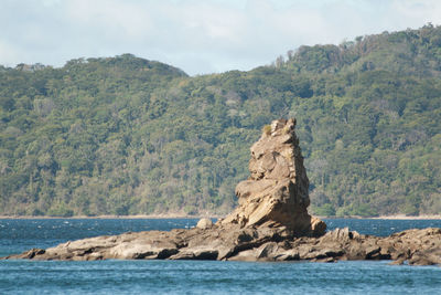 Scenic view of sea and rocks against sky