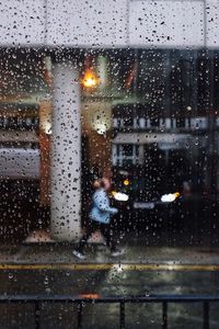 City seen through wet window during rainy season