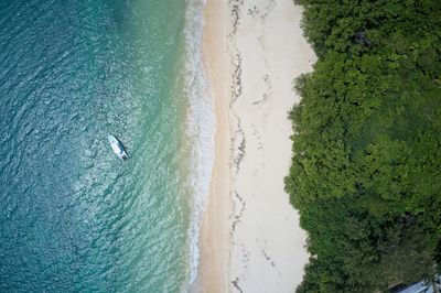 Aerial view of single kayak against backdrop of sea, sand and beach, seychelles.