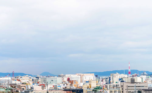 High angle view of buildings by sea against sky