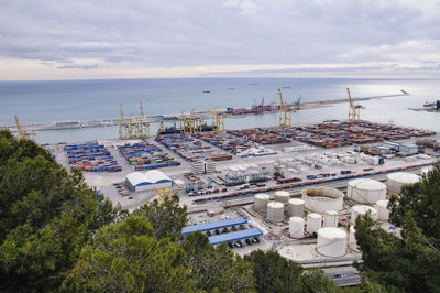 High angle view of buildings and sea against sky