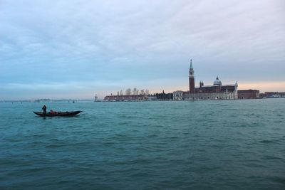 St marks square by grand canal against cloudy sky during sunset