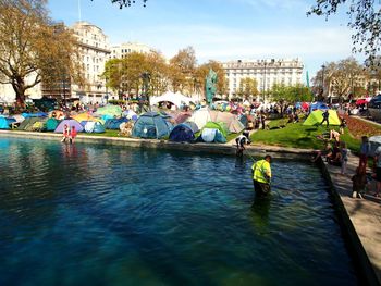 Group of people by river in city