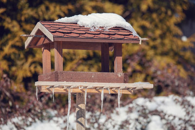 Close-up of birdhouse on table in park during winter