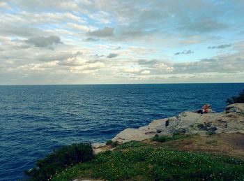 Scenic view of sea against cloudy sky