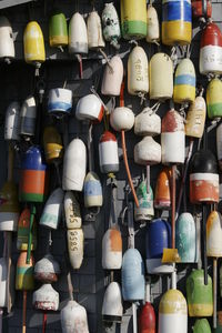 Close-up of colorful buoys hanging on wall