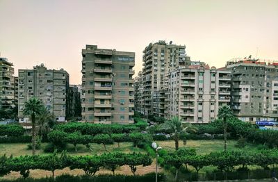 Buildings in city against clear sky