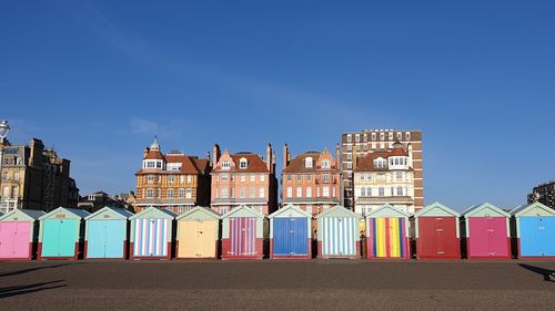 Multi colored buildings against blue sky in city