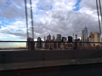 City skyline against cloudy sky