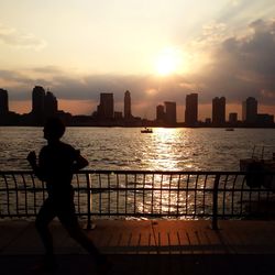 Sunset over river in city