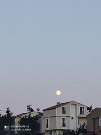 Low angle view of buildings against clear sky at night