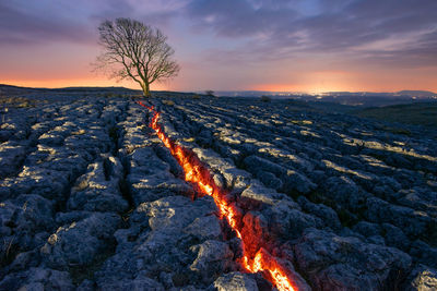 Scenic view of land against sky during sunset