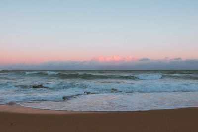 Scenic view of sea against clear sky during sunset