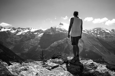 Rear view of man standing on rock