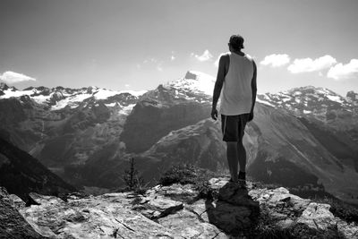 Rear view of man standing on rock