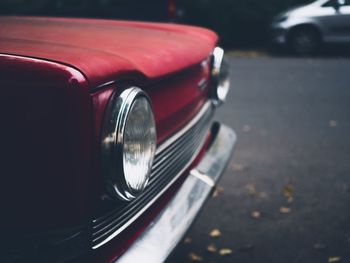 Close-up of red vintage car on street