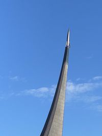 Low angle view of skyscraper against blue sky