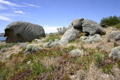 Rocks on landscape against sky