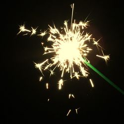 Low angle view of firework display at night