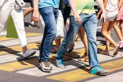 Low section of people walking on road