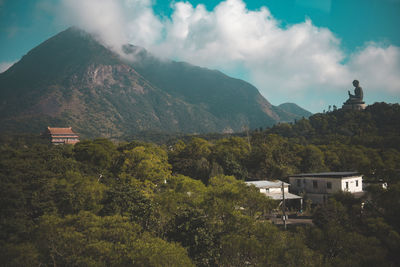 Scenic view of mountains and trees against sky