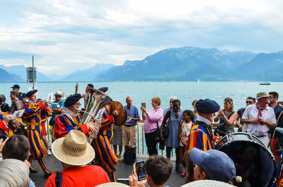 Group of people on boat in sea against sky