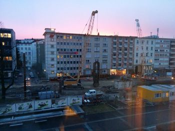 Construction site against sky at dusk