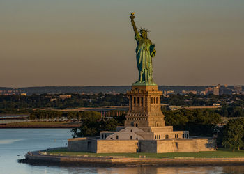 Statue of liberty against sky during sunset
