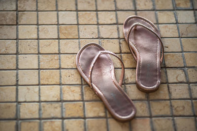 High angle view of slippers on tiled floor