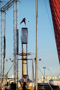 Low angle view of crane against clear sky