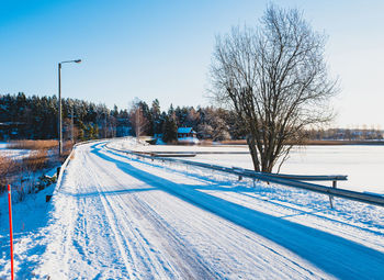 Snow covered landscape against clear sky