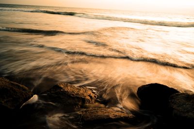 Close-up of sea waves at sunset