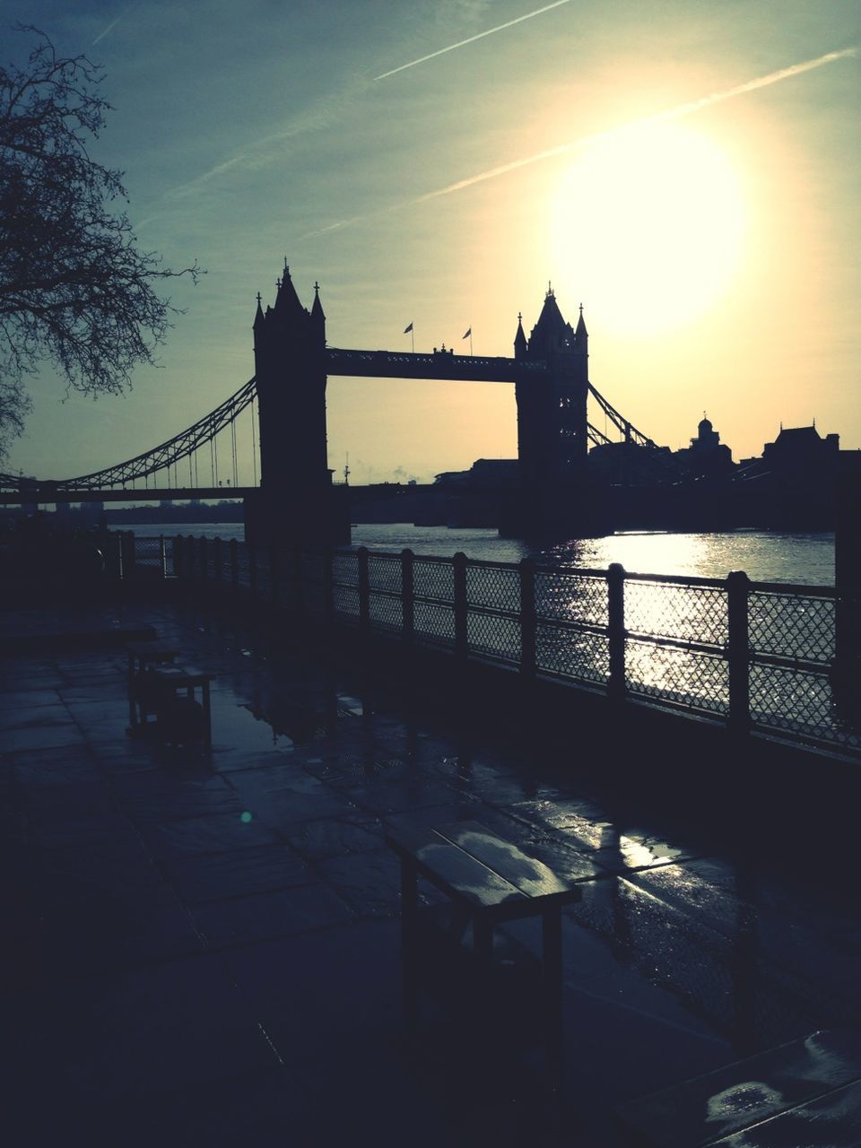 built structure, sunset, architecture, silhouette, water, bridge - man made structure, connection, sun, river, sky, railing, sunlight, building exterior, bridge, sunbeam, reflection, nature, pier, outdoors, city