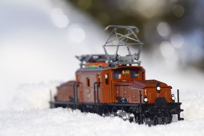 Train on snow against sky during winter