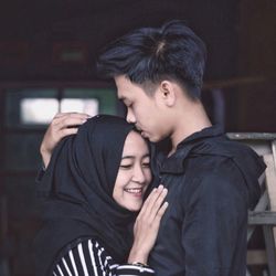 Portrait of young couple holding hands