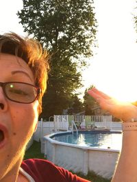 Close-up of man wearing sunglasses against sky in city