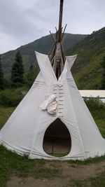 Tent on field against sky