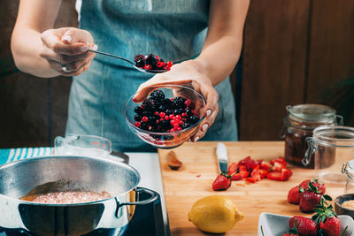 Midsection of woman preparing food