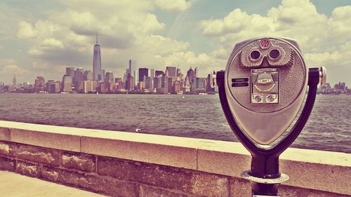 View of city by river against buildings