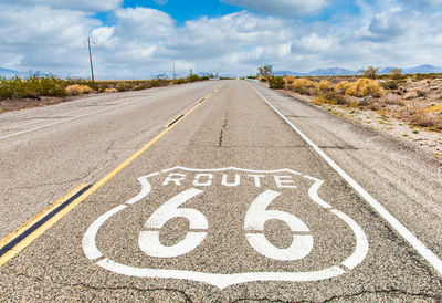 Road sign against sky