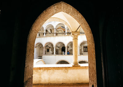 Historic building seen through arch window