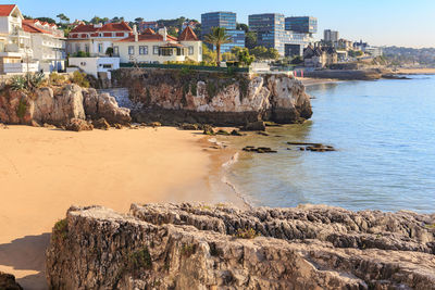 Panoramic view of sea and buildings against sky