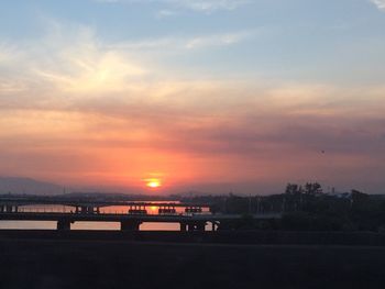 Scenic view of river against sky during sunset