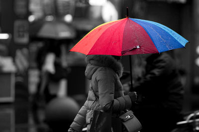 Rear view of woman with red umbrella