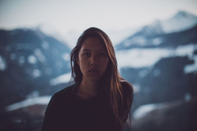 Close-up of young woman against sky