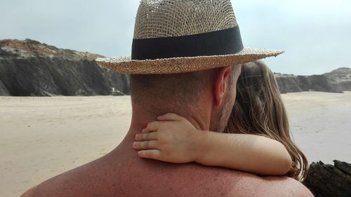Rear view of shirtless man wearing hat