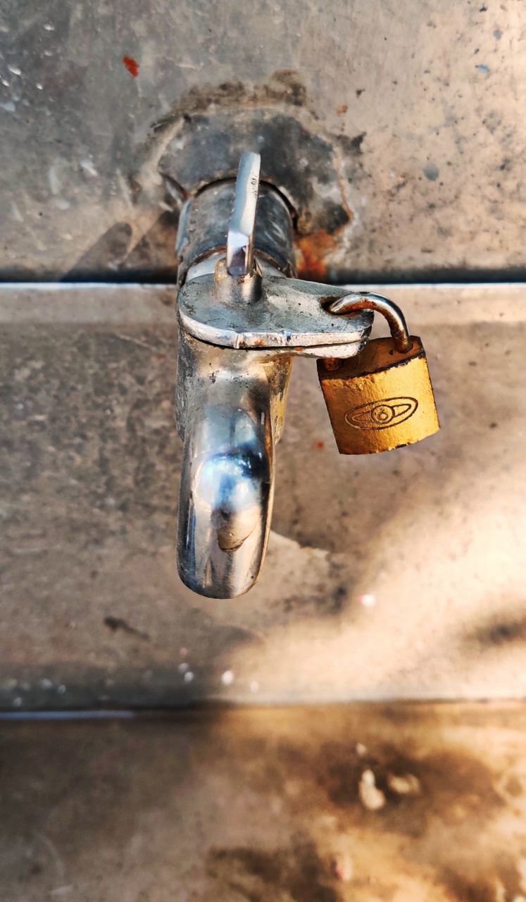 HIGH ANGLE VIEW OF PADLOCK ON BLACK AND WHITE WALL