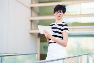 Side view of young woman using mobile phone